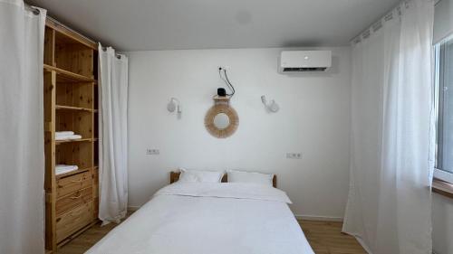 a bedroom with a bed and a mirror on the wall at Затишне місце біля парку in Kyiv