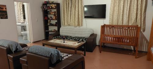 a living room with a couch and a table and a crib at Haika Georges' Homestay in Arusha