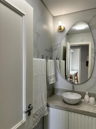 a bathroom with a sink and a mirror at Refúgio Sofisticado Beira Mar in Florianópolis