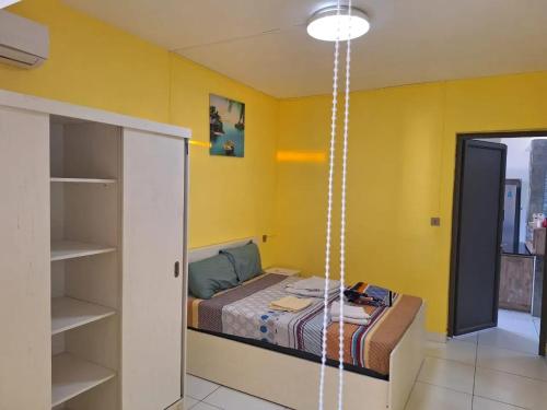 a room with a bed and a yellow wall at Harmonious Villa in Flic-en-Flac with Private Pool in Flic-en-Flac