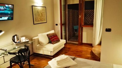 a living room with a white couch and a chair at Attico Barocco in Lecce