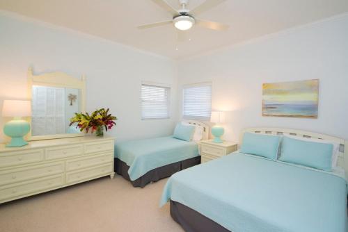 a bedroom with two beds and a ceiling fan at Northern Lights #6 Condo in Old Man Bay