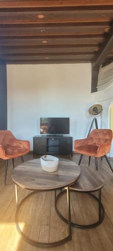 a living room with a table and two chairs at Appartement en centre ville in Bernay