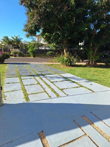two pictures of a street with a sidewalk at Harmonious Villa in Flic-en-Flac with Private Pool in Flic-en-Flac