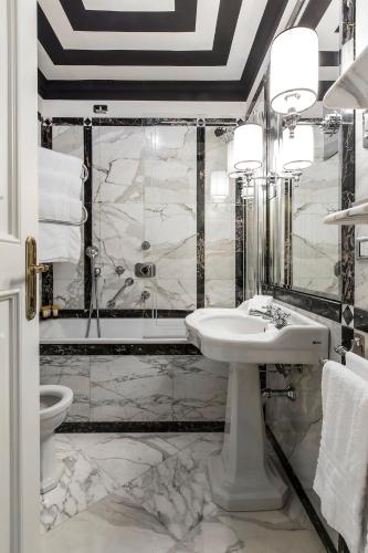a bathroom with a sink and a shower at Helvetia&Bristol Firenze – Starhotels Collezione in Florence