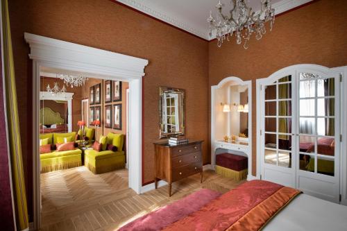 a bedroom with a bed and a living room at Helvetia&Bristol Firenze – Starhotels Collezione in Florence