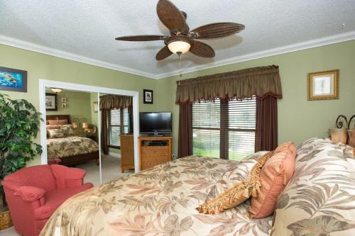 a bedroom with a bed and a ceiling fan at Georgetown Villas #203 in George Town