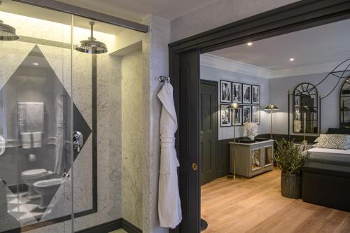 a bathroom with a walk in shower and a glass door at Helvetia&Bristol Firenze – Starhotels Collezione in Florence