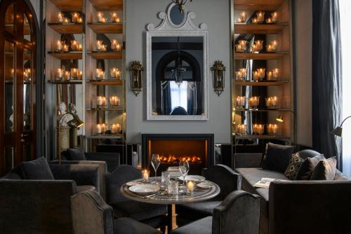a restaurant with a fireplace and a table and chairs at Helvetia&Bristol Firenze – Starhotels Collezione in Florence