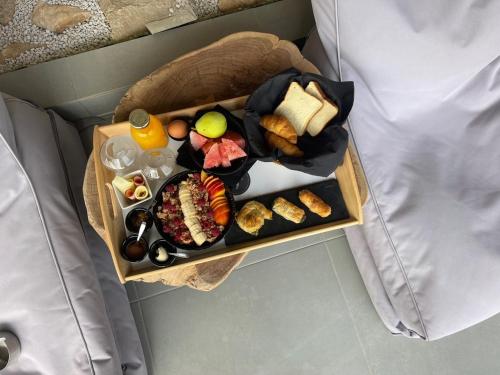 a plate of food on a tray on a table at Olvion Luxury Living in Kallithea Halkidikis