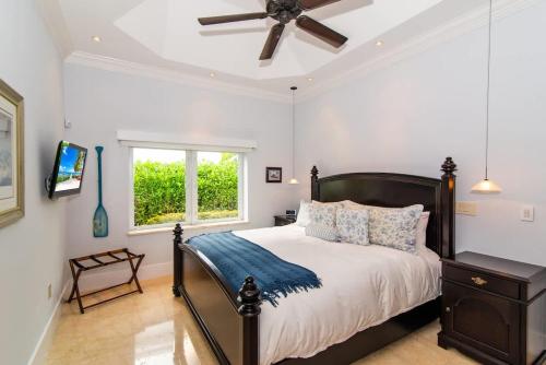 a bedroom with a bed and a ceiling fan at Faroway Luxury Villa in Half Way Pond