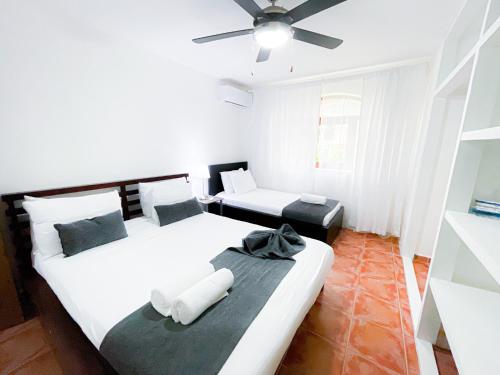 a bedroom with two beds and a ceiling fan at LOS CORALES Resort VILLAS & Apartments WIFI BEACH Club & SPA in Punta Cana