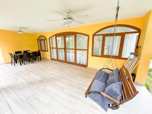 a living room with a hanging couch and a dining room at LOS CORALES Resort VILLAS & Apartments WIFI BEACH Club & SPA in Punta Cana