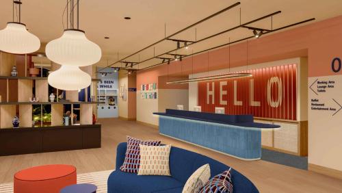 a lobby of a hello store with a blue couch at Holiday Inn Express & Suites Lisbon - Príncipe Real by IHG in Lisbon