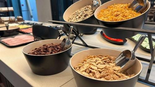 a group of bowls of food on a counter at Holiday Inn Express & Suites Lisbon - Príncipe Real by IHG in Lisbon