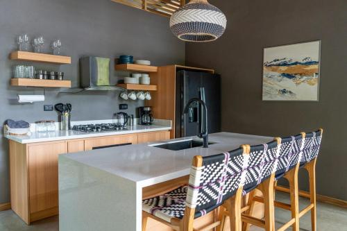 a kitchen with a kitchen island with a sink at Villa Asencia with pool and AC near Arrecife beach in Punta Uva