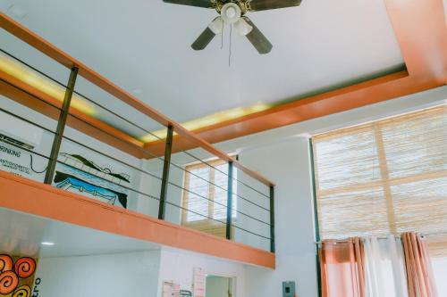 a ceiling fan in a room with a shelf at The Bistro House - Loft Unit - Vigan in Vigan