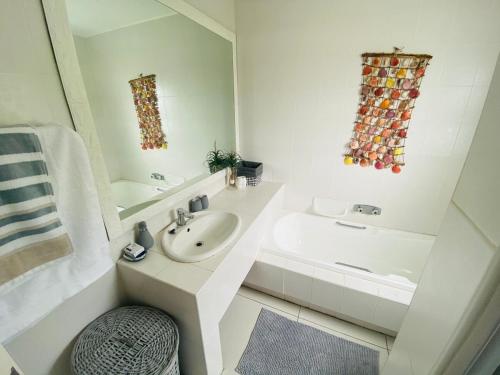 ein weißes Badezimmer mit Waschbecken und Badewanne in der Unterkunft Greek little Getaway - Paros Complex Apartment in Ballito