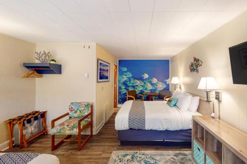 a hotel room with a bed and a chair at Lamplighter Inn Group Stay 2 in Bandon