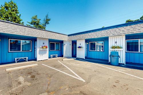 a blue and white building with a parking lot at Lamplighter Inn Group Stay 2 in Bandon