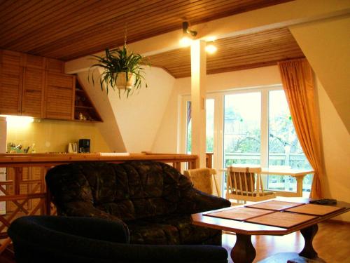 a living room with a couch and a table at Männi Guesthouse in Haapsalu