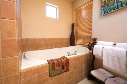 a bath tub sitting next to a window in a bathroom at Inn at Eagle Mountain in Scottsdale