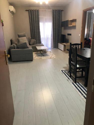 a living room with a couch and a table at Apartment in Tirana