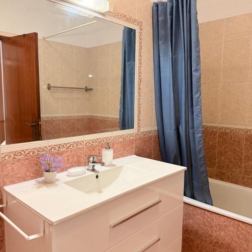 a bathroom with a sink and a mirror at Sunny Marisol T2 in Aroeira