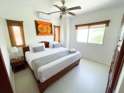 a bedroom with a bed and a ceiling fan at LOS CORALES Resort VILLAS & Apartments WIFI BEACH Club & SPA in Punta Cana