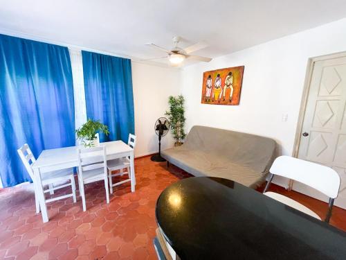 a living room with a couch and a table at LOS CORALES Resort VILLAS & Apartments WIFI BEACH Club & SPA in Punta Cana
