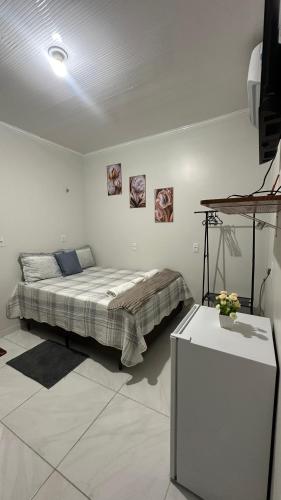 Ένα ή περισσότερα κρεβάτια σε δωμάτιο στο Aconchego Hospedagem