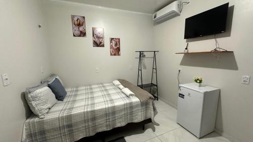 Ένα ή περισσότερα κρεβάτια σε δωμάτιο στο Aconchego Hospedagem