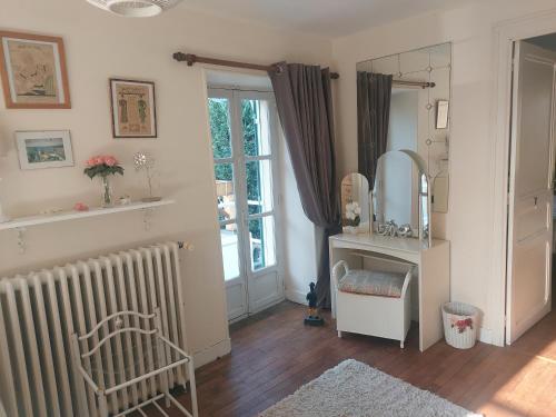 a living room with a radiator and a mirror at 2 Bed House with Mountain View Garden and Bbq in Confolens