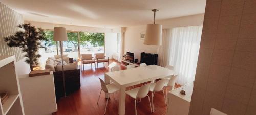 a living room with a white table and chairs at La Maison Piaf in Esposende