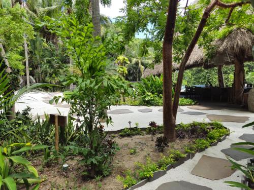 a garden with trees and a walkway at Tokipa at Punta Sayulita in Sayulita
