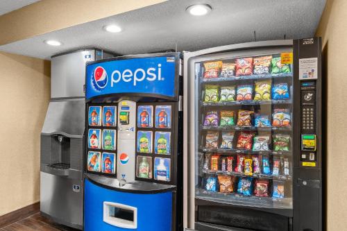 two soda machines in a store with food and drinks at Red Roof Inn Lansing East - MSU in Lansing