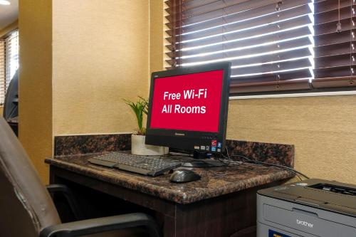 a computer monitor sitting on top of a desk at Red Roof Inn Lansing East - MSU in Lansing