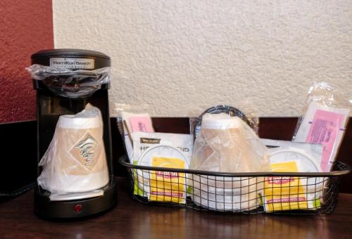 a basket of food and a coffee maker on a table at Red Roof Inn Lansing East - MSU in Lansing