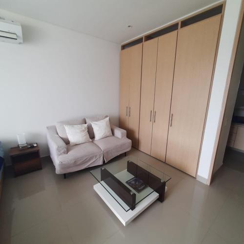 a living room with a couch and a coffee table at Reserva Del Mar Apartamentos in Gaira