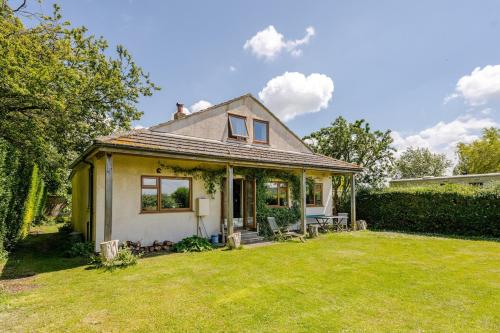 a small house with a lawn in front of it at The Patch at Snettisham Beach in Snettisham