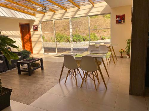 a dining room with a table and chairs at Las Hortensia's Casa De Huespedes in Tababela