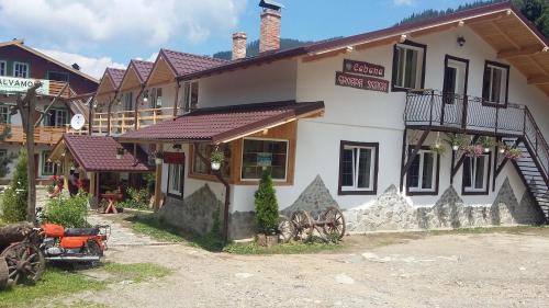 a building with a sign on the side of it at Cabana Groapa Seaca in Petroşani