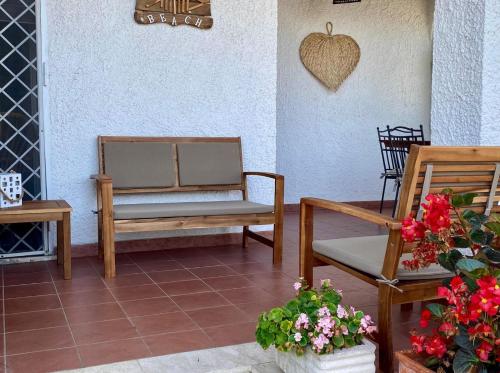 a patio with two chairs and an apple on the wall at Circeo-Terracina Villa Sul Mare in Terracina