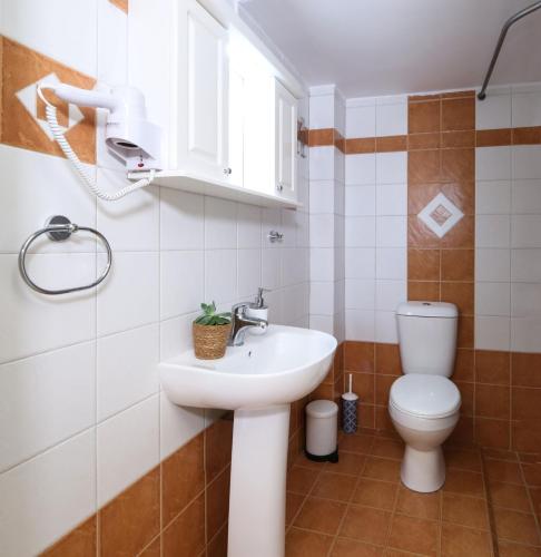 a bathroom with a sink and a toilet at Kiveri Gems Houses in Kivérion