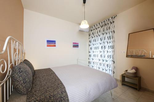 a bedroom with a bed and a mirror at Kiveri Gems Houses in Kivérion
