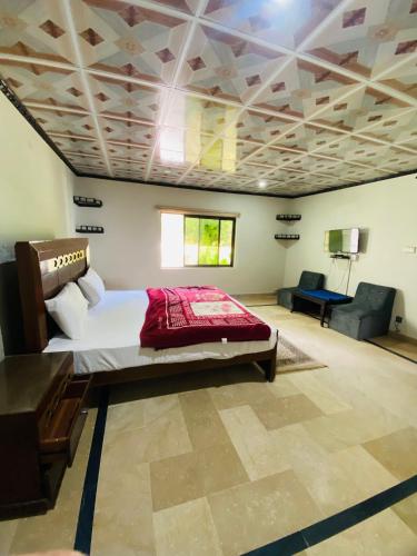 a bedroom with a bed and a living room at Mount Vista Resort in Murree