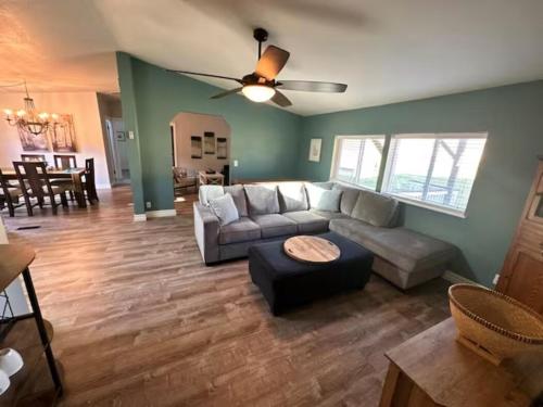 a living room with a couch and a table at Enchanting Getaway Farmhouse And Tiny House Duo in Jacksonville