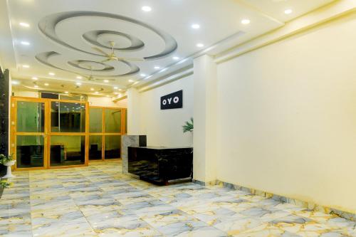 a lobby with a fireplace and a ceiling at Hotel O The Suresh Mahal Resort in Jaipur