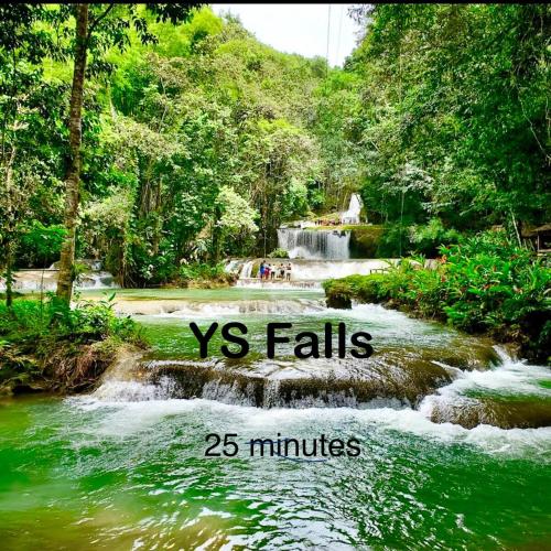 a waterfall in a forest with the words vs falls and minutes at Aristo Oasis, Luxury Guest suite in Santa Cruz in Santa Cruz