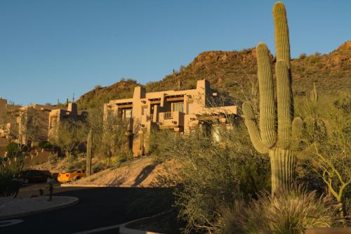 a house in the middle of a desert with a cactus at Inn at Eagle Mountain in Scottsdale